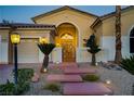 Beautiful home exterior showcasing stone steps, desert landscaping, and a decorative front gate at 4624 Leon De Oro Dr, Las Vegas, NV 89129