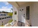 Front door of the condo with a white door, window, and a welcome mat on the porch at 4865 S Torrey Pines Dr # 206, Las Vegas, NV 89103