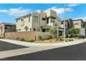 Corner house with desert landscaping, gray garage door, tan stucco, and a modern design at 513 Monarch Ridge Ct, North Las Vegas, NV 89084