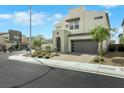 Modern home featuring desert landscaping, and a gray garage door, located in a neighborhood at 513 Monarch Ridge Ct, North Las Vegas, NV 89084
