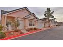 Street view of beige single-story home with a red curb and well-maintained landscaping at 5236 Ladyhawk Way, Las Vegas, NV 89118
