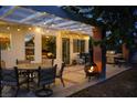 Inviting backyard patio with string lights, outdoor seating, and a cozy brick fireplace at 5609 Red Bluff Dr, Las Vegas, NV 89130