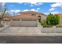 Charming single-Gathering home featuring a well-manicured front yard, a three-car garage, and a red tile roof at 5609 Red Bluff Dr, Las Vegas, NV 89130