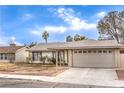Charming single-story home featuring a two-car garage and a welcoming front porch at 5809 Robin Ln, Las Vegas, NV 89108