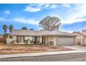 Charming single-story home featuring a two-car garage and a welcoming front porch at 5809 Robin Ln, Las Vegas, NV 89108