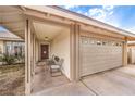 Cozy covered porch area with seating leading to a two-car garage at 5809 Robin Ln, Las Vegas, NV 89108