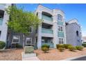 Exterior view of a three-story condominium building with well-maintained landscaping at 6955 N Durango Dr # 2099, Las Vegas, NV 89149