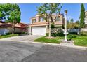 Beautiful shot of this home's exterior with a terracotta roof and mature landscaping at 8244 Horseshoe Bend Ln, Las Vegas, NV 89113