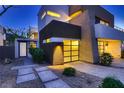 Modern home displaying a well-lit entry, contemporary design and low maintenance landscaping at 917 Vegas View Dr, Henderson, NV 89052