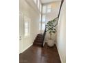 Bright entryway with dark wood floors, staircase and many vertical windows providing natural light at , Las Vegas, NV 89135