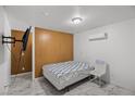 Bedroom featuring tile floors, a wall mounted television and neutral decor at 1004 Yucca Ave, Las Vegas, NV 89104