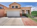 Inviting two-story home with a lush walkway and a two car garage at 103 Trout Creek Ct, Las Vegas, NV 89123
