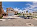 Two-story home with a well-manicured lawn, tile roof, and beautiful landscaping at 103 Trout Creek Ct, Las Vegas, NV 89123