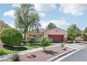 Charming single-story home with desert landscaping, mature shade trees, and a two-car garage at 10601 India Hawthorn Ave, Las Vegas, NV 89144