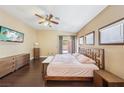 Spacious bedroom with wood floors, ceiling fan, and access to the outdoor patio area at 10601 India Hawthorn Ave, Las Vegas, NV 89144