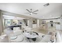 Bright and spacious living room with modern furnishings and open floor plan to kitchen and dining at 11618 Costa Linda Ave, Las Vegas, NV 89138