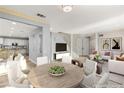 Open-concept living and dining area with modern decor and abundant natural light at 11784 Golden Moments Ave, Las Vegas, NV 89138