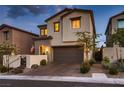 Charming two-story home boasts a neutral color scheme, a well-maintained front yard, and a two-car garage at 12053 Arrebol Ave, Las Vegas, NV 89138