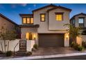 Charming two-story home boasts a neutral color scheme, a well-maintained front yard, and a two-car garage at 12053 Arrebol Ave, Las Vegas, NV 89138