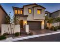 Charming two-story home boasts a neutral color scheme, a well-maintained front yard, and a two-car garage at 12053 Arrebol Ave, Las Vegas, NV 89138