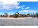 Inviting single-story home with gated driveway and desert landscaping at 1615 Palora Ave, Las Vegas, NV 89169