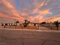 Ranch style home with gated entrance and landscaped front yard at sunset at 1615 Palora Ave, Las Vegas, NV 89169