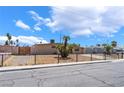 Single-story home with desert landscaping and wrought iron fence at 1615 Palora Ave, Las Vegas, NV 89169