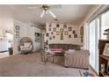Comfortable living room with plush carpeting, a large sectional sofa, and a ceiling fan at 1911 Winter Hill St, Las Vegas, NV 89106