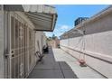 Long, narrow side yard with concrete slab and partial awning at 1911 Winter Hill St, Las Vegas, NV 89106