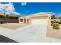 Single-story home with low-maintenance landscaping and a spacious two-car garage at 2205 Beacon Ridge Dr, Las Vegas, NV 89134