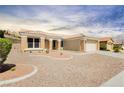 A single-story home with desert landscaping and a tile roof, featuring neutral colors at 2205 Beacon Ridge Dr, Las Vegas, NV 89134