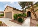 Inviting home exterior features lush landscaping and covered entryway at 2357 Aztec Ruin Way, Henderson, NV 89044