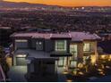 Stunning exterior view of the modern home, showcasing clean lines and expansive windows with city view at 25 Rockstream Dr, Henderson, NV 89012