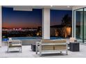 Outdoor patio with modern furniture, offering a serene space with city skyline views at 25 Rockstream Dr, Henderson, NV 89012