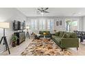 Bright living room featuring stylish decor, large windows, and a ceiling fan at 2932 Tranquil Brook Ave, Henderson, NV 89044