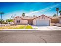 Inviting single-story home with a two-car garage, complemented by a bright and airy sky at 3016 Light Wind Ct, Las Vegas, NV 89108
