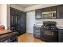 Cozy kitchen with black cabinetry, stainless steel microwave, and gas range at 3016 Light Wind Ct, Las Vegas, NV 89108