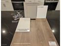 Material board showcasing upgraded cabinet, paint, quartz, luxury vinyl plank, and faucet samples at 3632 Stoppani Ave, Henderson, NV 89044