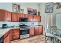 Spacious kitchen with wooden cabinets, stainless steel appliances, and an eat-in dining area at 3924 Quiet Pine St # 201, Las Vegas, NV 89108