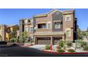 The home features a two-car garage and well-manicured landscaping and hardscape with desert vegetation at 3975 N Hualapai Way # 147, Las Vegas, NV 89129