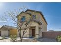 View of the house with an attached garage, featuring desert landscaping and an inviting covered entrance at 4539 Cotton Quail Ave, Las Vegas, NV 89115