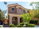 Two-story home with a tiled roof, desert landscaping, and a well-maintained front yard at 519 Brinkburn Point Ave, Las Vegas, NV 89178