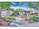 Beautiful single-story home with lush front yard landscaping and a quaint arched entryway at 5772 Arbor Oak Cir, Las Vegas, NV 89142