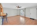 Bright living room with hardwood floors, ceiling fan, and a window with natural light at 5772 Arbor Oak Cir, Las Vegas, NV 89142