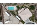 Aerial view of a house with a pool, RV parking and tile roof in a well-maintained community at 6116 Camas Canyon Ave, Las Vegas, NV 89130