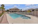 Inviting backyard pool and spa, surrounded by a white fence and lush landscaping, perfect for outdoor relaxation at 6116 Camas Canyon Ave, Las Vegas, NV 89130