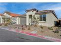 Charming single-story home with a well-maintained front yard, two-car garage and desert landscaping at 6544 Sandero Springs St, Las Vegas, NV 89166