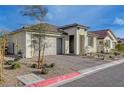 Charming single-story home with a well-maintained front yard, desert landscaping, and a two-car garage at 6544 Sandero Springs St, Las Vegas, NV 89166