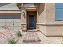 Inviting front entrance with a brick walkway and decorative stone accents at 713 Webber Park St, Henderson, NV 89011