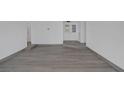 Spacious living room featuring new wood-look flooring, and bright white walls at 720 Sam Jonas Dr, Las Vegas, NV 89145